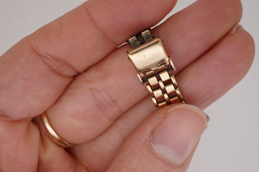 A lady's 9ct gold Omega manual wind wrist watch, with baton numerals, case diameter 20mm, on an associated 9ct gold bracelet. Gross weight 21.2 grams. Condition - poor to fair.